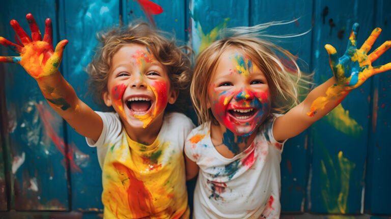 Kids laughing and having fun shows dirty hands with colorful paint